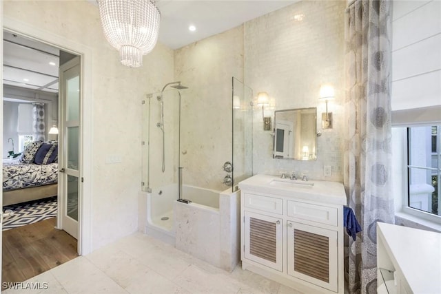510 2nd St S Unit 102, Naples, FL 34102 - bathroom with connected bathroom, vanity, a bath, a chandelier, and a shower