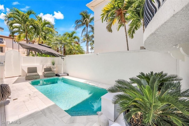 510 2nd St S Unit 102, Naples, FL 34102 - view of pool featuring a fenced backyard and a patio area