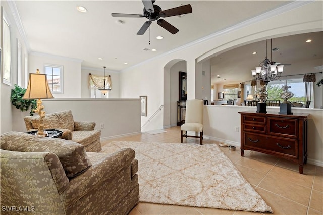 living area featuring arched walkways, a wealth of natural light, and light tile patterned floors