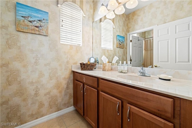 full bath featuring wallpapered walls, baseboards, tile patterned floors, and vanity