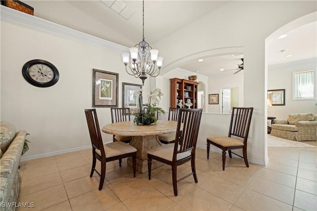 dining room with crown molding, arched walkways, light tile patterned floors, and ceiling fan with notable chandelier