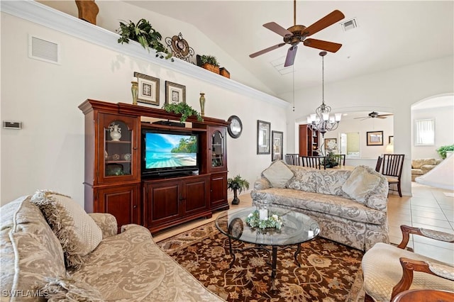 living area featuring visible vents, arched walkways, ceiling fan with notable chandelier, and light tile patterned floors