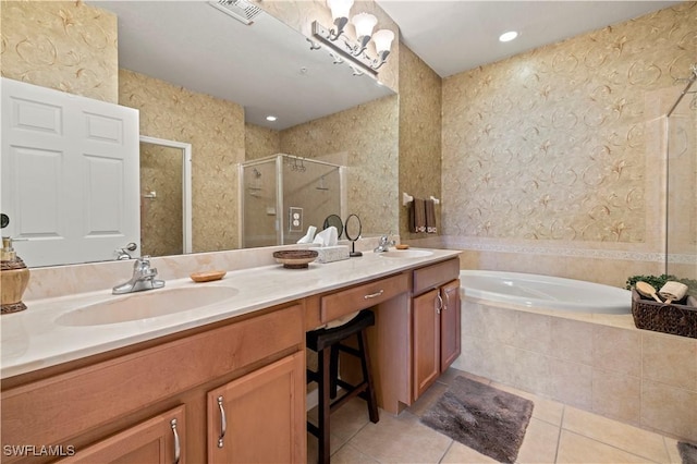 full bathroom featuring a sink, a shower stall, tile patterned floors, a garden tub, and double vanity