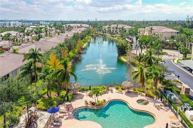drone / aerial view with a water view and a residential view
