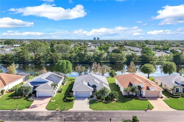 birds eye view of property with a water view and a residential view