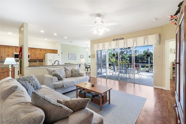living room featuring baseboards, recessed lighting, ceiling fan, and wood finished floors