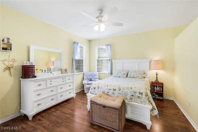 bedroom featuring baseboards, a ceiling fan, and dark wood-style flooring