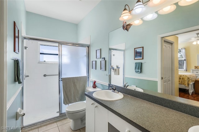ensuite bathroom with vanity, toilet, connected bathroom, tile patterned floors, and a shower stall