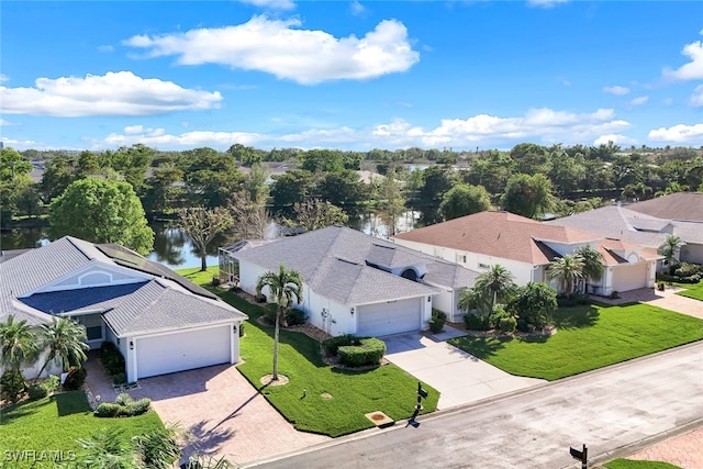 birds eye view of property featuring a water view and a residential view