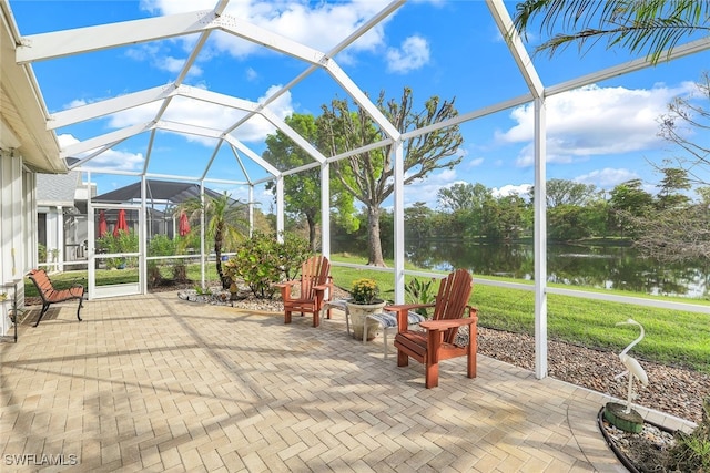 sunroom featuring a water view