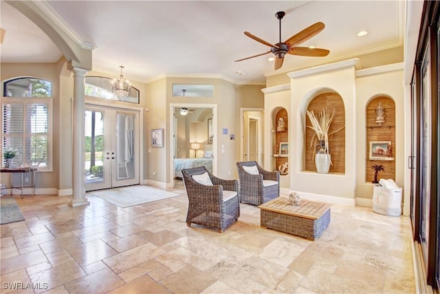 foyer entrance featuring crown molding, a ceiling fan, baseboards, and ornate columns