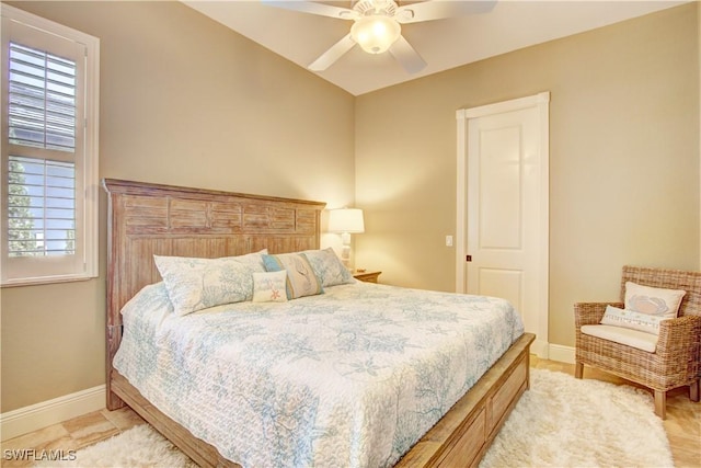 bedroom featuring baseboards, multiple windows, and a ceiling fan