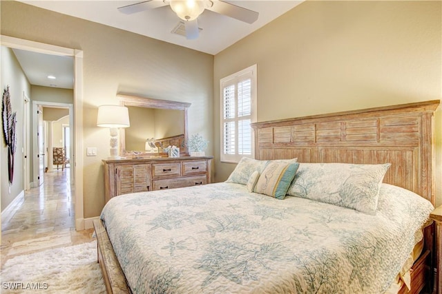 bedroom with baseboards and a ceiling fan