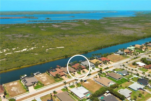 birds eye view of property with a water view and a residential view