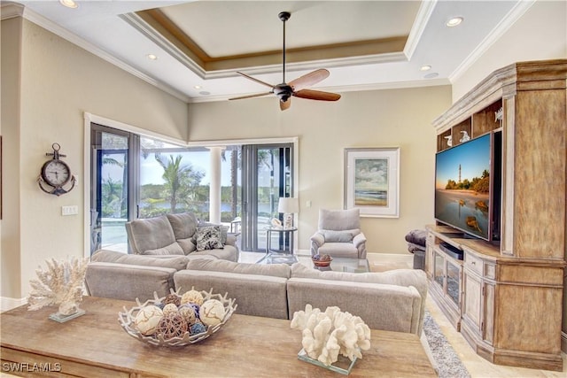 living area featuring a ceiling fan, a tray ceiling, recessed lighting, and ornamental molding