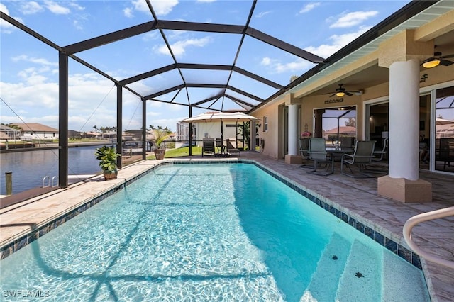 2536 SW 28th Pl, Cape Coral, FL 33914 - outdoor pool featuring a patio, a water view, outdoor dining area, a ceiling fan, and a lanai