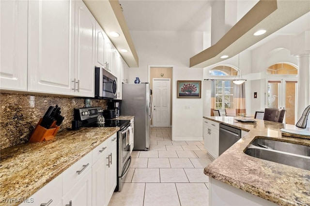 2536 SW 28th Pl, Cape Coral, FL 33914 - kitchen with appliances with stainless steel finishes, a sink, recessed lighting, white cabinetry, and tasteful backsplash