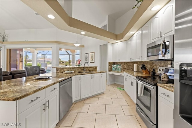 2536 SW 28th Pl, Cape Coral, FL 33914 - kitchen featuring backsplash, stainless steel appliances, stone counters, and a sink