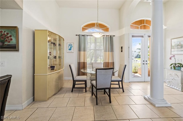2536 SW 28th Pl, Cape Coral, FL 33914 - dining area with ornate columns, a towering ceiling, plenty of natural light, and light tile patterned flooring
