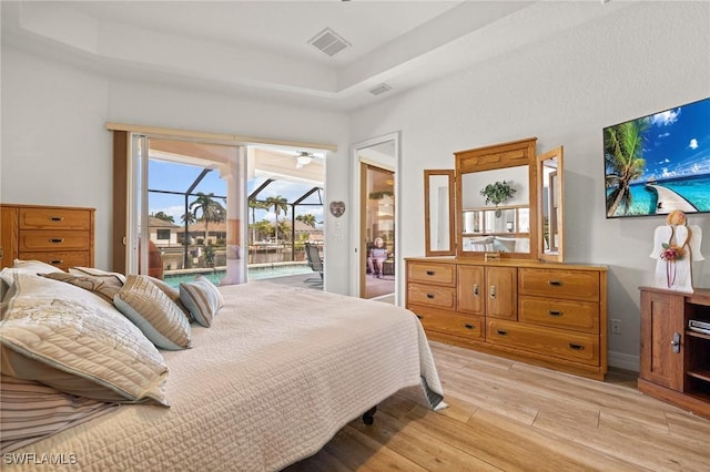 2536 SW 28th Pl, Cape Coral, FL 33914 - bedroom featuring visible vents, access to exterior, a raised ceiling, and light wood-type flooring