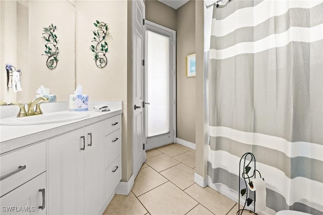 2536 SW 28th Pl, Cape Coral, FL 33914 - bathroom featuring vanity, tile patterned flooring, baseboards, and a shower with shower curtain