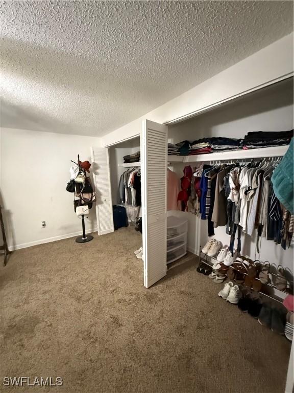 bedroom with carpet flooring and a textured ceiling