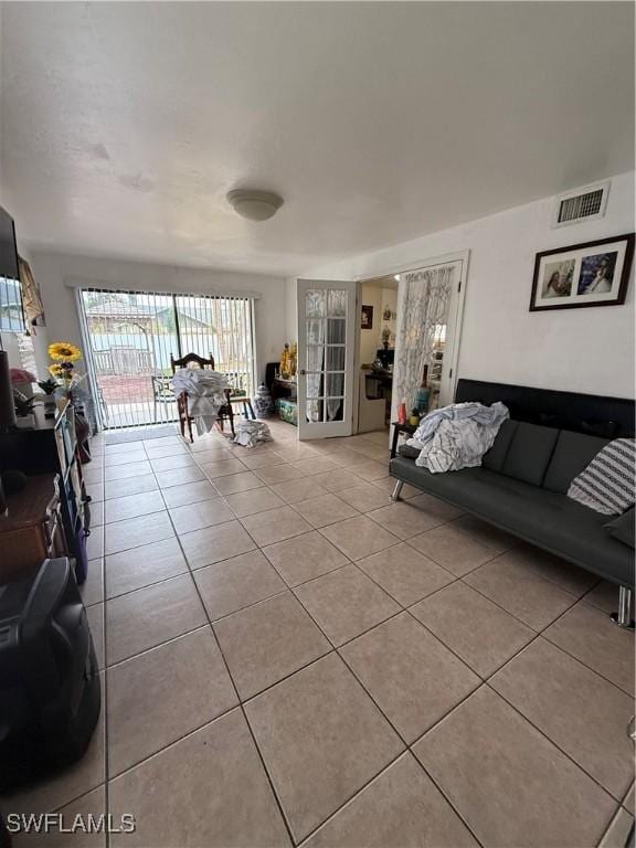 living room featuring visible vents and tile patterned flooring