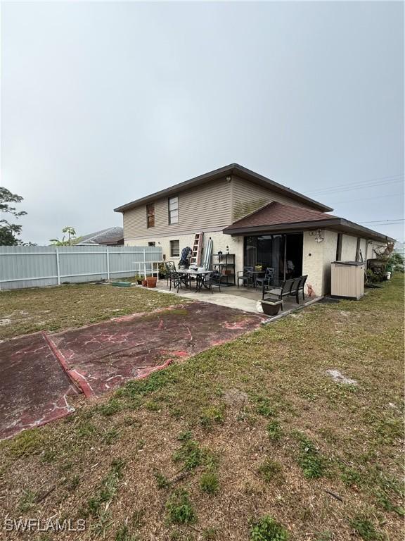 back of house with a lawn, a patio area, and fence