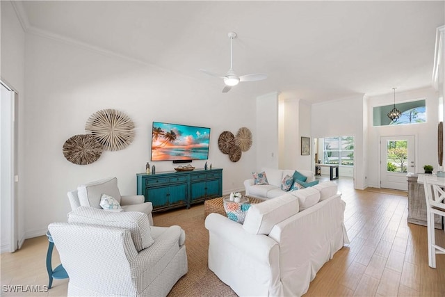 living room featuring light wood-type flooring, ceiling fan, and crown molding