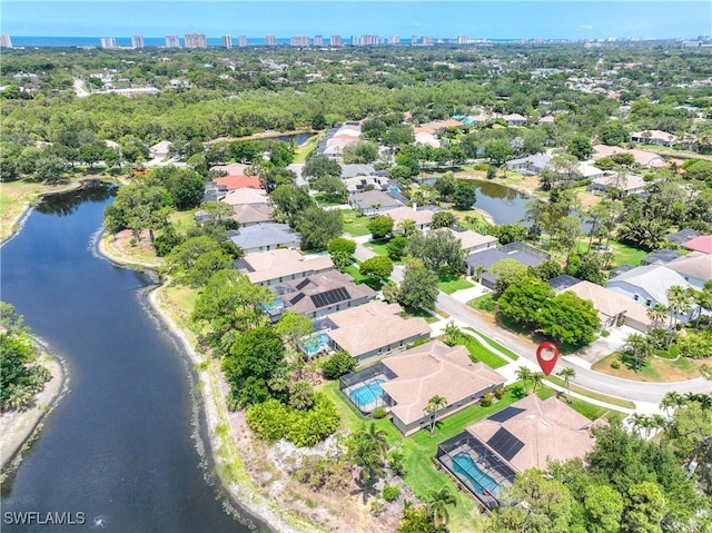aerial view of property and surrounding area featuring a nearby body of water, nearby urban area, and nearby suburban area
