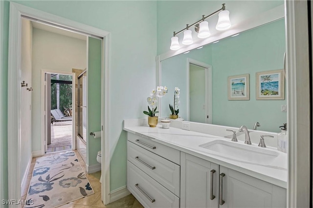 full bathroom featuring toilet, vanity, tile patterned flooring, and combined bath / shower with glass door