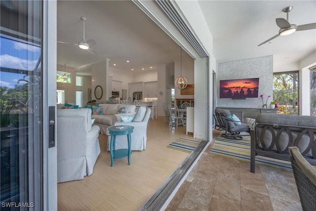 living room with a ceiling fan and recessed lighting