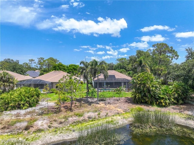 rear view of house featuring a lanai