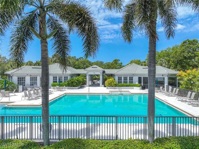 community pool featuring fence and a patio area