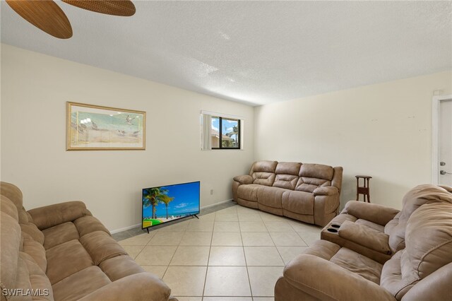 7136 Blanquilla Ct, Fort Myers, FL 33908 - living room featuring baseboards, light tile patterned floors, a ceiling fan, and a textured ceiling