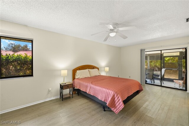 7136 Blanquilla Ct, Fort Myers, FL 33908 - bedroom featuring access to exterior, wood finished floors, baseboards, a textured ceiling, and ceiling fan