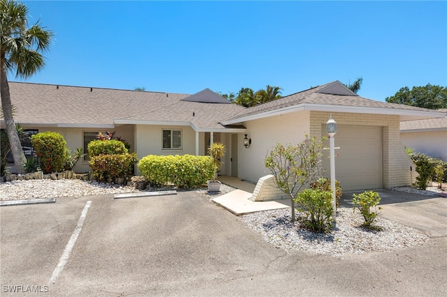 7136 Blanquilla Ct, Fort Myers, FL 33908 - ranch-style home featuring an attached garage, roof with shingles, and stucco siding
