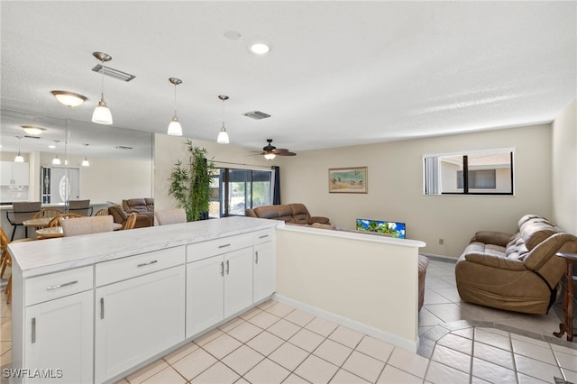 7136 Blanquilla Ct, Fort Myers, FL 33908 - kitchen with open floor plan, white cabinetry, and pendant lighting