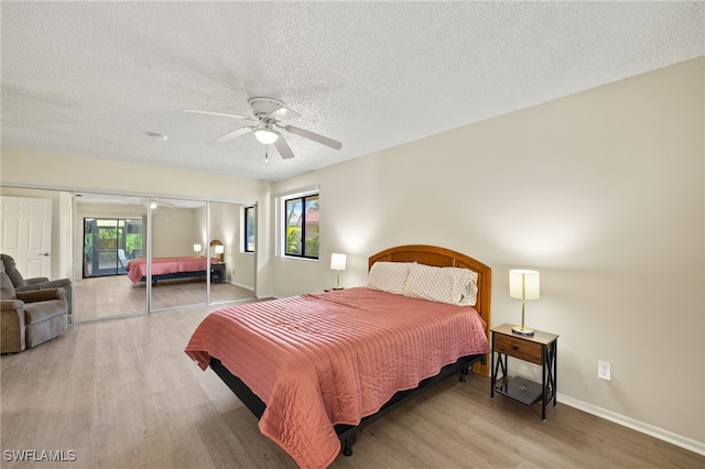 7136 Blanquilla Ct, Fort Myers, FL 33908 - bedroom with wood finished floors, a textured ceiling, a ceiling fan, baseboards, and access to exterior