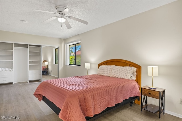 7136 Blanquilla Ct, Fort Myers, FL 33908 - bedroom featuring wood finished floors, a closet, a textured ceiling, a ceiling fan, and baseboards