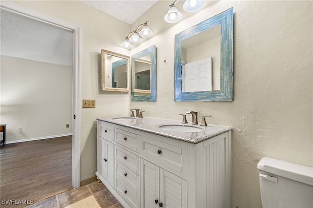 7136 Blanquilla Ct, Fort Myers, FL 33908 - full bath featuring toilet, double vanity, a textured ceiling, and baseboards