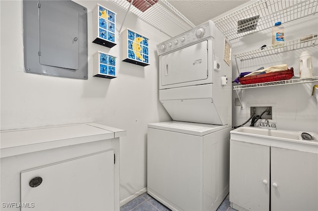 7136 Blanquilla Ct, Fort Myers, FL 33908 - washroom featuring stacked washer / drying machine, cabinet space, and electric panel