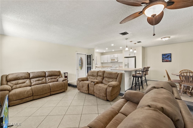 7136 Blanquilla Ct, Fort Myers, FL 33908 - living area featuring ceiling fan, light tile patterned floors, a textured ceiling, baseboards, and recessed lighting