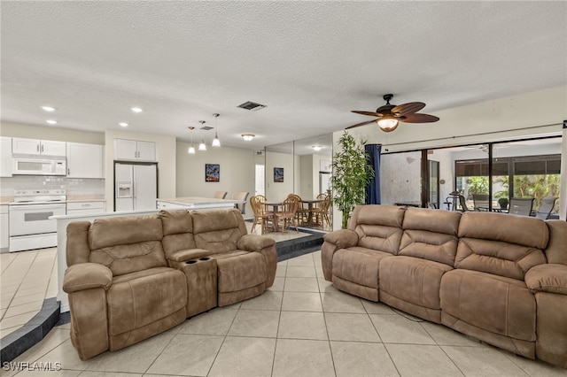 7136 Blanquilla Ct, Fort Myers, FL 33908 - living room with light tile patterned floors, a ceiling fan, recessed lighting, and a textured ceiling