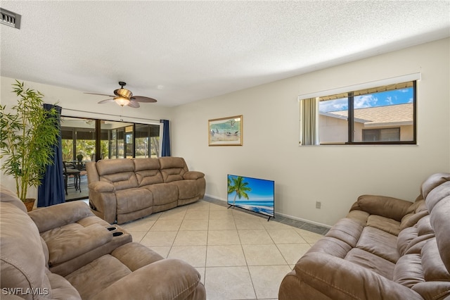 7136 Blanquilla Ct, Fort Myers, FL 33908 - living area with plenty of natural light, a textured ceiling, a ceiling fan, light tile patterned floors, and baseboards