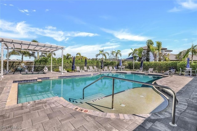 community pool featuring a pergola, a patio, and fence