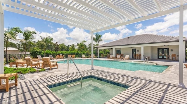 community pool featuring a hot tub, a pergola, french doors, a patio area, and fence
