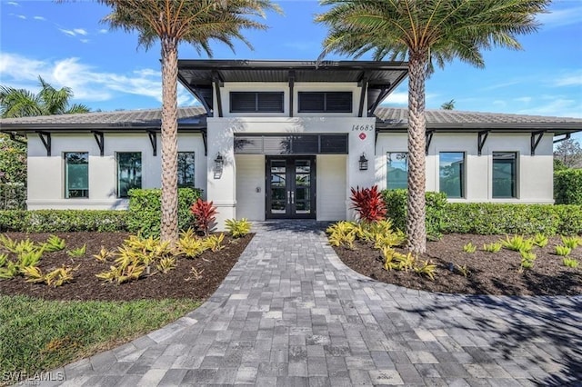 view of front of house featuring french doors and stucco siding