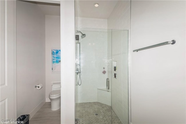 full bathroom featuring a shower stall and toilet