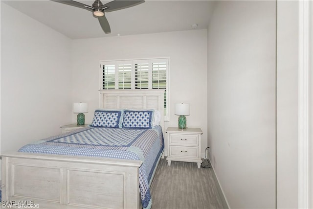 bedroom with baseboards, wood finished floors, and ceiling fan